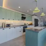 Sage green painted kitchen cabinets, a popular cabinet painting color choice for Delmar, NY homes